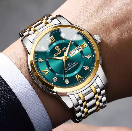 Luxury wristwatch with green dial and gold accents on a person's wrist.